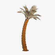 A large metal sunset palm tree, standing 14ft tall, against a white background. The sculpture's intricate design features realistic palm fronds and textured trunk, creating a lifelike appearance.