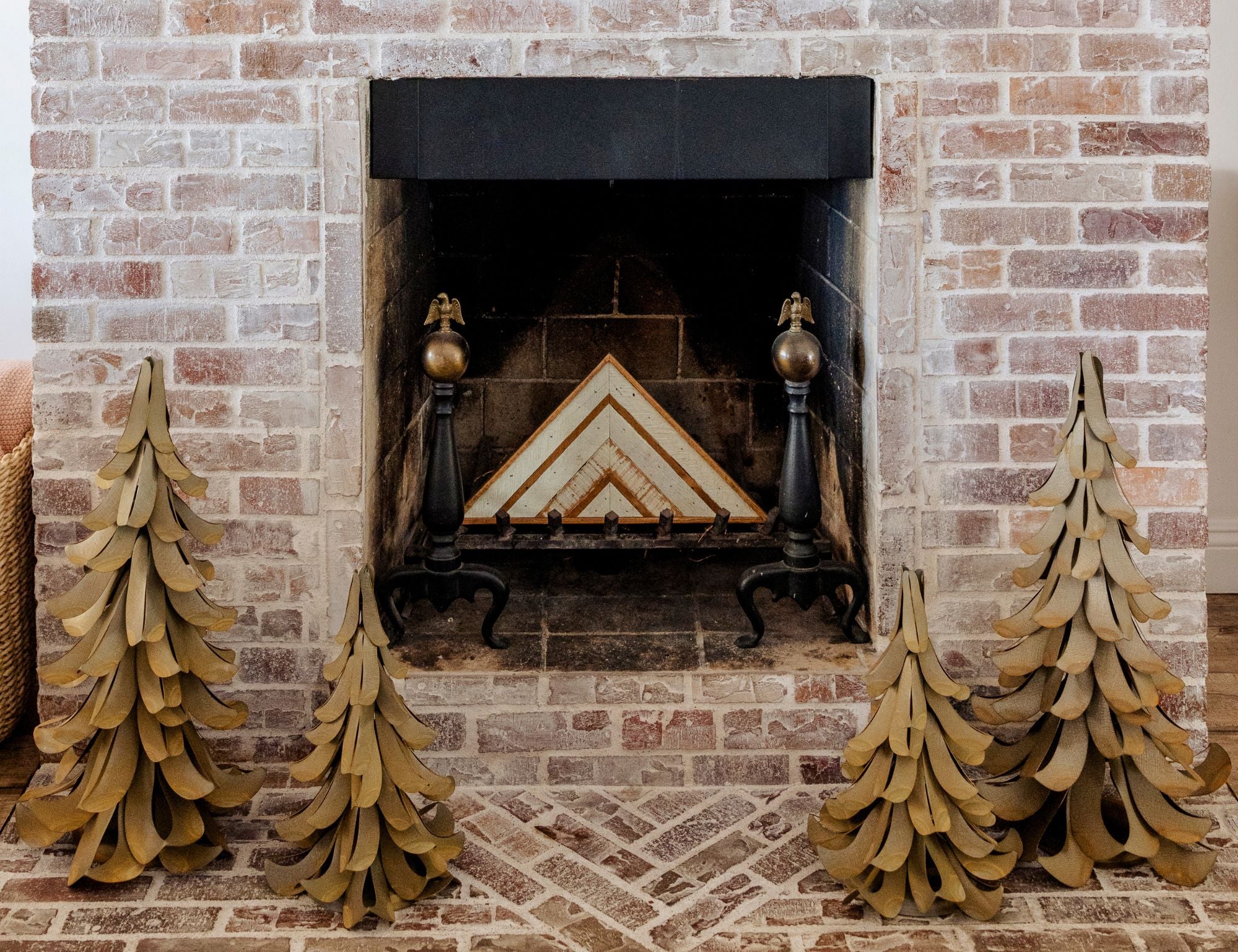 Metal Cedar Trees on either side of a fireplace