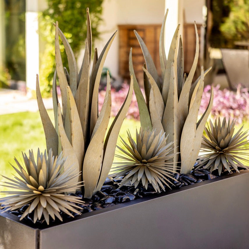 Decorative planter with artificial succulents in a garden setting