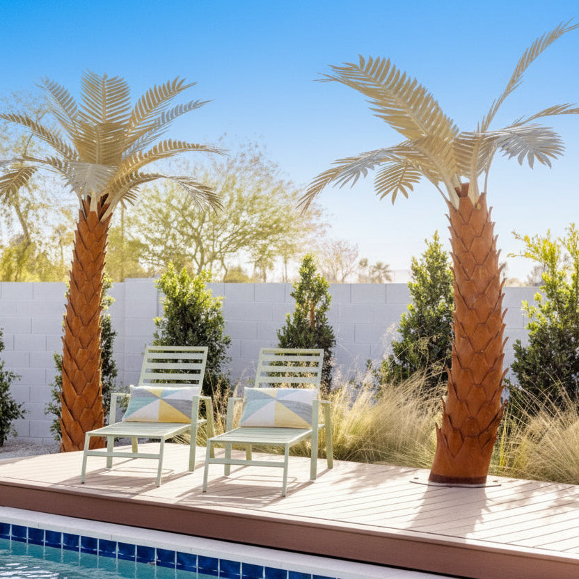 Pool area with chairs, palm trees, and a fence in the background