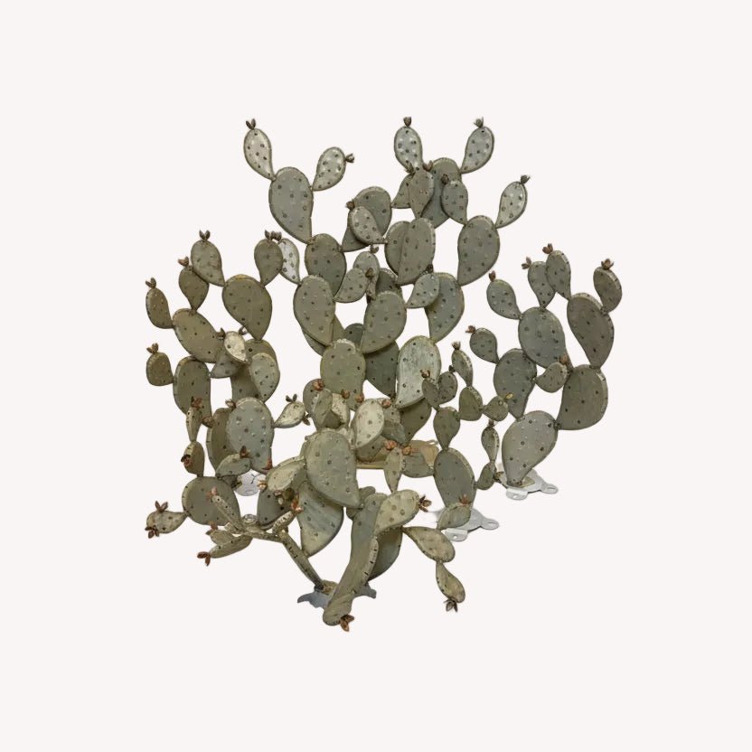 Metal sculpture of a cactus on a white background