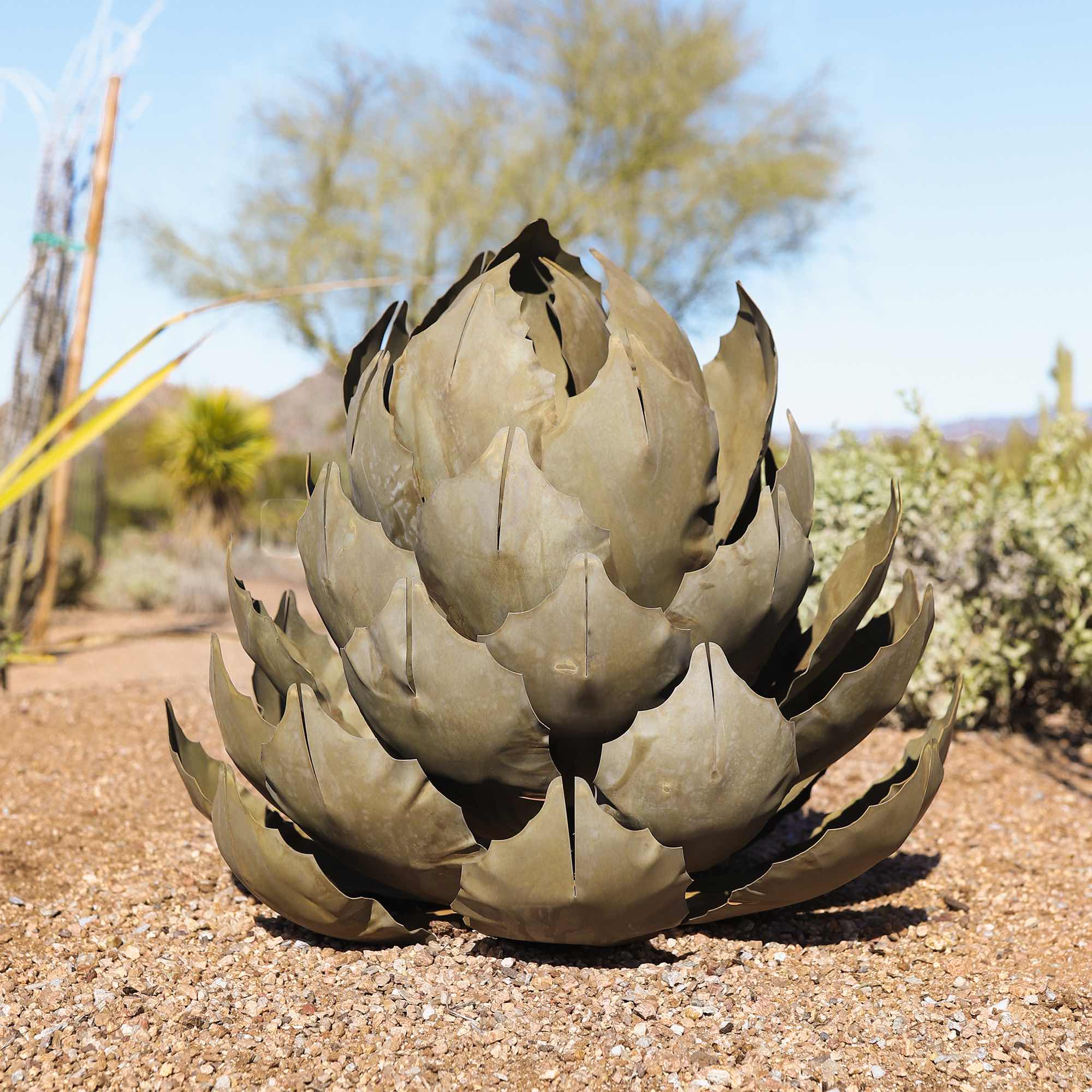 A large handcrafted metal artichoke agave located in the desert.