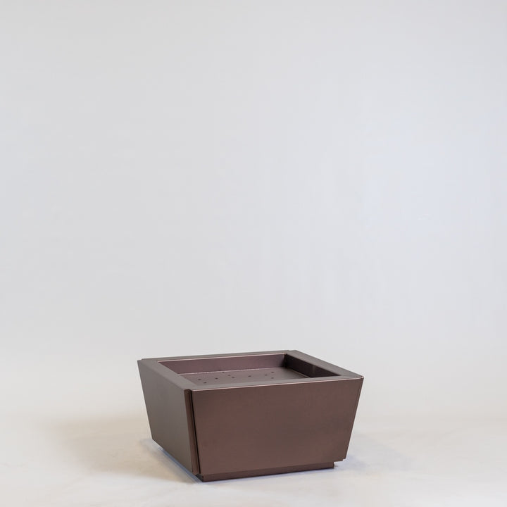 A large metal steel reyes planter in copper, in a white background.