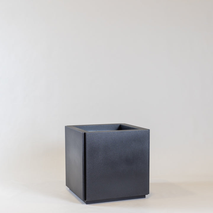 A large metal butler planter in graphite, on a white background. Handcrafted with all-weather steel.